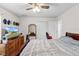 Bedroom featuring closet, fan, TV and mirror making it a comfortable haven for rest and relaxation at 4196 Hoffman Ave, Spring Hill, FL 34606