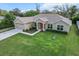 Aerial view of a well-maintained single-Gathering home featuring lush landscaping and an attached garage at 4196 Hoffman Ave, Spring Hill, FL 34606