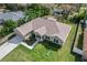 Aerial view of the home showing its well-manicured lawn, landscaping, and proximity to neighborhood amenities at 4196 Hoffman Ave, Spring Hill, FL 34606