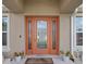 Welcoming front entrance boasts an ornate glass door, sidelights and manicured landscaping at 4196 Hoffman Ave, Spring Hill, FL 34606