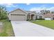 Charming single Gathering home featuring a spacious lawn, attached two car garage and mature landscaping at 4196 Hoffman Ave, Spring Hill, FL 34606