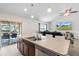 Open-concept kitchen with an island bar and seamless flow into the living area at 4196 Hoffman Ave, Spring Hill, FL 34606