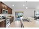 Bright kitchen featuring stainless steel appliances, wooden cabinets, modern countertops and a sliding glass door at 4196 Hoffman Ave, Spring Hill, FL 34606