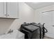 Laundry room featuring a sink, Samsung washer, dryer and a door to the outdoors at 4196 Hoffman Ave, Spring Hill, FL 34606