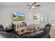 Bright living room featuring high ceilings, a large television, and comfortable seating at 4196 Hoffman Ave, Spring Hill, FL 34606