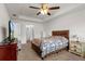 The main bedroom has a ceiling fan and tray ceilings with two closets and neutral paint at 4196 Hoffman Ave, Spring Hill, FL 34606