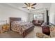 This main bedroom features a tray ceiling, ceiling fan and sitting area with updated furnishings at 4196 Hoffman Ave, Spring Hill, FL 34606