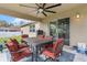 Cozy covered patio with ceiling fan and outdoor dining set, perfect for relaxing and entertaining at 4196 Hoffman Ave, Spring Hill, FL 34606