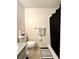 Functional bathroom featuring a toilet, shower with curtain, and a towel rack with decorative towels at 4622 Blossom Blvd # D, Zephyrhills, FL 33542