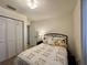 This is a cozy bedroom with a comfortable bed, closet and a nightstand with a lamp at 4622 Blossom Blvd # D, Zephyrhills, FL 33542