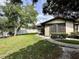 Cozy home featuring a well-maintained lawn and a charming walkway leading to the front door, surrounded by lush greenery at 4622 Blossom Blvd # D, Zephyrhills, FL 33542