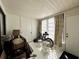 Bright sunroom with white walls, a window, exterior door and contents in need of organizing at 4622 Blossom Blvd # D, Zephyrhills, FL 33542