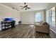 Spacious living room with vaulted ceiling, modern flooring, and large windows at 6212 Abbott Station Dr, Zephyrhills, FL 33542