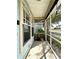 A screened in front porch with potted plants and neutral coloring at 6212 Abbott Station Dr, Zephyrhills, FL 33542