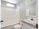 The bathroom is all-white with a shower and tub combination at 13024 Dania St, Hudson, FL 34667