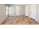 Bright bedroom featuring wood-look floors, a window, and two closets at 13024 Dania St, Hudson, FL 34667