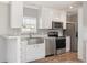 Kitchen featuring stainless steel appliances, granite counters and open concept at 13024 Dania St, Hudson, FL 34667