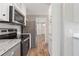Stylish kitchen features stainless steel appliances and a view into the hallway at 13024 Dania St, Hudson, FL 34667