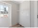 Functional mud room includes a window door, shelving, and light wood-look flooring at 13024 Dania St, Hudson, FL 34667