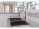 Close-up of a stainless steel sink with a modern faucet and granite countertops at 13024 Dania St, Hudson, FL 34667