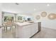 Eat-in kitchen with breakfast bar and stainless appliances adjacent to the dining room at 3060 Clewiston St, Spring Hill, FL 34609