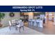 Modern kitchen with sleek black appliances, island seating, and an adjacent dining area at 3060 Clewiston St, Spring Hill, FL 34609