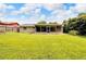 Lush backyard featuring mature trees and a screened patio at 2140 N Bay Hills Blvd, Safety Harbor, FL 34695