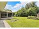 Expansive backyard with lush landscaping and screened patio at 2140 N Bay Hills Blvd, Safety Harbor, FL 34695