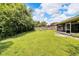 A large backyard featuring a spacious lawn and a wooden fence at 2140 N Bay Hills Blvd, Safety Harbor, FL 34695