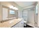 Updated bathroom featuring granite counters and frameless glass shower at 2140 N Bay Hills Blvd, Safety Harbor, FL 34695