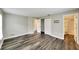An open bedroom flows to the bathroom, featuring modern, dark wood floors, closet at 2140 N Bay Hills Blvd, Safety Harbor, FL 34695