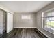 A cozy bedroom featuring wood floors and a bright window at 2140 N Bay Hills Blvd, Safety Harbor, FL 34695