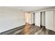 A bright bedroom features modern, dark wood floors, closet, and neutral paint at 2140 N Bay Hills Blvd, Safety Harbor, FL 34695