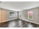 Bedroom featuring wood floors and three windows for ample natural light at 2140 N Bay Hills Blvd, Safety Harbor, FL 34695