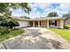 View of the home's front exterior, showcasing the garage, entry, and driveway at 2140 N Bay Hills Blvd, Safety Harbor, FL 34695