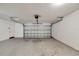 Empty garage with a metal garage door and white painted walls at 2140 N Bay Hills Blvd, Safety Harbor, FL 34695