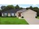 Charming single-story home with a two-car garage, manicured lawn, and inviting red front door at 10263 Jollett St, Spring Hill, FL 34608