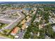 Aerial view of a residential neighborhood with lush greenery, a lake, and ample parking spaces at 2756 Clubhouse Dr # 101, Sarasota, FL 34232