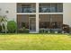 Backyard featuring a well-maintained lawn and screened enclosure with shade and seating at 2756 Clubhouse Dr # 101, Sarasota, FL 34232