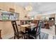 Cozy dining room with wood table and chairs adjacent to a living room with fireplace at 2756 Clubhouse Dr # 101, Sarasota, FL 34232