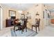 Traditional dining room with a dark wood table set, elegant chandelier, and beige walls, perfect for Gathering meals at 2756 Clubhouse Dr # 101, Sarasota, FL 34232