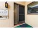 Welcoming front entrance with a decorative glass storm door and painted stucco siding at 2756 Clubhouse Dr # 101, Sarasota, FL 34232