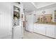 Efficient kitchen design with white cabinets, granite counters, and a pass-through window at 2756 Clubhouse Dr # 101, Sarasota, FL 34232