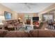 Cozy living room with a fireplace, comfortable couches, and natural light streaming through sliding glass doors at 2756 Clubhouse Dr # 101, Sarasota, FL 34232