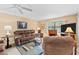 Comfortable living room featuring a fireplace, plush seating, and a large window offering natural light and views at 2756 Clubhouse Dr # 101, Sarasota, FL 34232