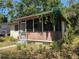 Charming single-story home with a cozy front porch and mature trees at 655 36Th S Ave, St Petersburg, FL 33705