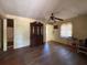 Spacious living room with wood floors, ceiling fan, and a vintage china cabinet at 655 36Th S Ave, St Petersburg, FL 33705
