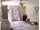 Living room with old flooring, ceiling fan, windows, and boxes and furniture at 665 36Th S Ave, St Petersburg, FL 33705