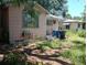 Side view of a single-story home with siding, showcasing its modest features and surrounding greenery at 665 36Th S Ave, St Petersburg, FL 33705