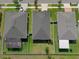 Aerial view of homes with fenced yards, showcasing roofs, landscaping, and neighborhood layout from above at 12905 Satin Lily Dr, Riverview, FL 33579